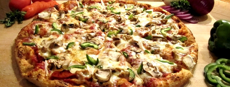 Pizza with green peppers, onion, and mushroom
